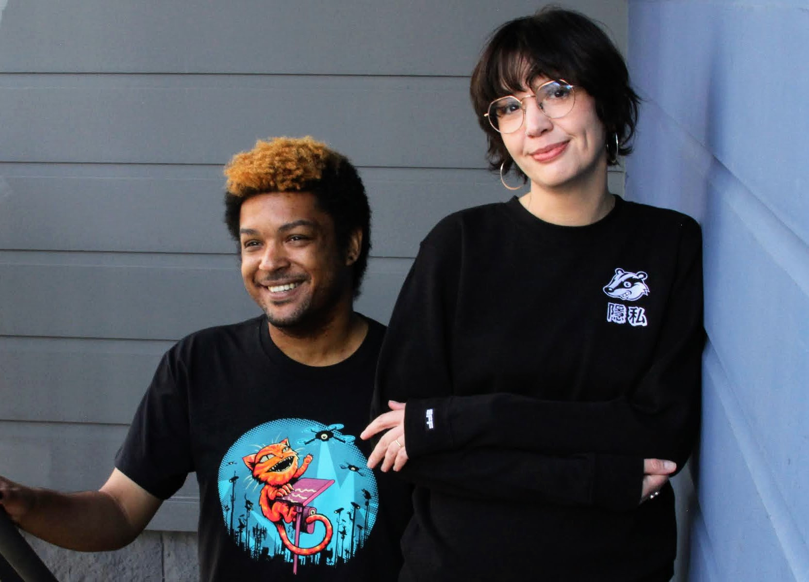 Get new EFF gear when you join! A person wears an EFF Claw Back member t-shirt on the left. A person on the right wears a black sweatshirt with the Privacy Badger mascot on the chest.